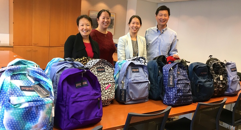 San Francisco Fellows Alumni with donated backpacks full of school supplies.