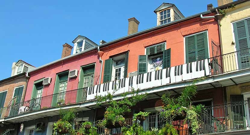 Jazzy and upbeat, the spirit of New Orleans salutes passersby from a balcony overlooking the French Quarter.